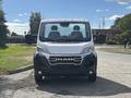 A 2023 RAM Promaster 3500 van is shown from the front with a silver body and black accents featuring the RAM logo prominently on the grille and two seats visible inside