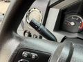Close-up of the steering wheel and dashboard controls of a 2019 Ford F-750 featuring a gear shift and instrument panel