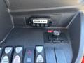 Dashboard controls of a 2017 Ford Transit-350 featuring buttons for lights and doors with a door ajar indicator and a rear flasher switch