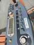 A control panel of a 2009 JLG E300AJP with various buttons knobs and switches for operating the equipment