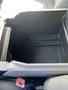 An empty storage compartment of a 2015 Ford F-150 interior with a textured plastic surface and a black finish