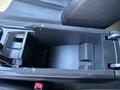 Interior view of a 2023 Fisker Ocean showing the center console with a storage compartment and sleek design elements