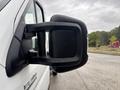 A close-up of the side mirror of a 2023 RAM Promaster 3500 highlighting its sturdy design and angular shape