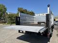 A 2019 Ford F-550 with a flatbed truck design featuring metallic sides and an open back ready for loading cargo