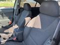 Interior of a 2006 Pontiac G6 featuring two front seats with fabric upholstery and a center console between them