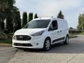 A white 2020 Ford Transit Connect van with a sleek design and side sliding door parked on a driveway