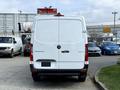 A white 2021 Mercedes-Benz Sprinter van viewed from the rear with a simple design and the manufacturer's logo visible on the back door