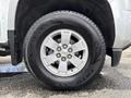 A close-up of a silver alloy wheel with a Chevrolet bowtie emblem on a 2018 Chevrolet Colorado tire marked with the brand name Toyo