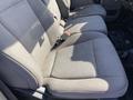 The image shows the front seats of a 2018 Ford F-150 with gray fabric upholstery and a center console area visible between the seats