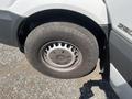 The image shows the wheel of a 2016 Mercedes-Benz Sprinter with a silver alloy rim and a well-worn tire featuring visible tread patterns