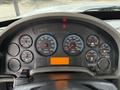 Close-up of the dashboard of a 2011 International 4300 showing various gauges including speedometer, RPM, fuel, oil pressure, and water temperature