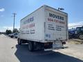 A white 2014 Hino 195 box truck with "MOVERS" and contact information printed on the sides