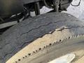 Close-up of a worn tire from a 2011 International 7500 showing visible tread wear and dirt buildup on the surface