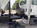 A 2013 International WorkStar truck featuring a black hydraulic system with visible pipes and a Rexroth component in the engine area