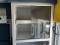 2013 Chevrolet Express with a glass front cabinet showcasing empty shelves inside