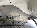 2023 GMC Savana undercarriage showing exposed components with tire tread in focus