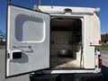 A 2016 Ford F-250 SD with its rear door open revealing an empty cargo area inside