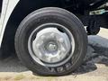 A close-up of a gray wheel on a 2011 Workhorse W62 featuring a silver hubcap and six lug nuts with a tire marked with the word "COTTAGE" and the size "G670-RV"