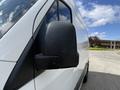 A close-up view of the side mirror of a 2022 Mercedes-Benz Sprinter van featuring a sleek design and a black casing