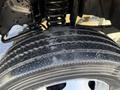 Close-up of a tire on a 2008 Ford F-550 showing tread pattern and details of the wheel and suspension components