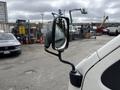 A 2009 Toyota Hiace with a side mirror visible in the foreground