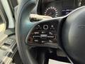 Close-up of the steering wheel controls of a 2023 Mercedes-Benz Sprinter showing buttons for cruise control and other settings