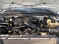 An exposed engine compartment of a 2009 Ford F-550 showing various components including the engine block hoses and fluid reservoirs