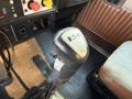 A close-up of a black Eaton gear shift lever in a 1996 Kenworth T800 truck's cabin with a textured grip and a neutral position indicator