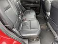 The image shows the rear seats of a 2016 Mitsubishi Outlander featuring black leather upholstery with three seat sections and seat belts installed