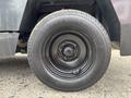 A close-up of a black tire mounted on a wheel with five lug nuts typical of a 2019 Madvac LS175 vehicle