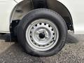 A silver alloy wheel with a black tire labeled Super Van 350 mounted on a 2010 Daihatsu Hijet