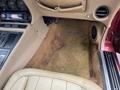 A 1970 Chevrolet Corvette with beige leather seats and a tan carpet interior featuring dashboard controls and audio system components