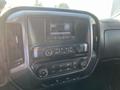 Interior dashboard of a 2015 Chevrolet Silverado 1500 featuring a touchscreen display and control buttons for media and climate settings