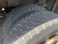 Close-up of a pair of heavy-duty tires with a rugged tread pattern mounted on a 2016 RAM 5500 vehicle
