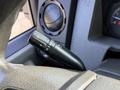 A close-up of the turn signal lever inside a 2018 Ford F-750 truck showing the controls for turn signals and windshield wipers