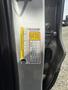 A 2015 Ford Escape driver's side door jamb with a visible vehicle information label detailing specifications and safety information