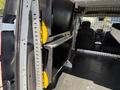 A 2021 Ford Transit Connect interior showing a partitioning system with two mounted black shelving units secured with yellow clamps