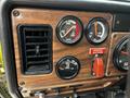 Dashboard of a 1995 Freightliner FL086 featuring gauges for temperature pressure and water levels along with an emergency shutdown switch and air vent