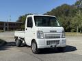 2009 Suzuki Carry in white with a compact design featuring a flatbed and a two-door cabin facing forward