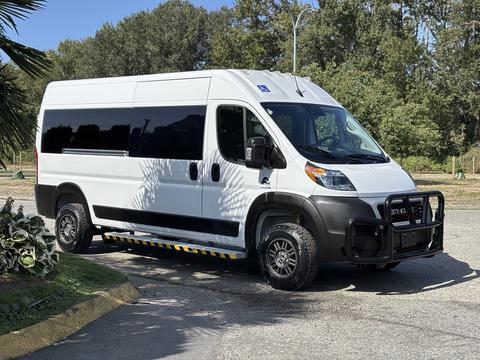 A white 2022 RAM Promaster 350 van with a black front grill and rugged black wheels parked on the roadside