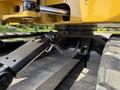 Close-up of a 2022 Caterpillar 306 excavator's hydraulic system featuring the arm and joint mechanisms with hoses and metal components visible