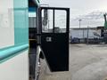 The open door of a 2020 Freightliner MT45 revealing the interior cabin with a dashboard and controls visible