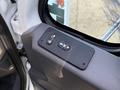 Close-up of a control panel on the door of a 2011 International 7500 showing buttons for locking and adjusting the window