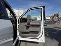 A 2018 Ford F-150 with its front driver-side door open displaying the interior features and seating