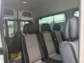 Interior of a 2009 Dodge Sprinter Van featuring multiple passenger seats with seatbelts and a partition behind the front seats
