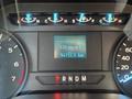 Dashboard of a 2019 Ford F-150 showing a digital odometer reading of 94712.5 km and a fuel range of 134 km to empty