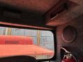 Interior view of a 2018 Sandvik Ranger DX800 featuring a control panel and a speaker near the ceiling with a red surface visible in the background