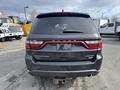 A black 2015 Dodge Durango Limited with a distinctive rear design featuring red accent lights and a towing hitch visible at the bottom
