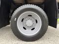 A close-up view of a wheel from a 2020 Ford F-550 featuring a gray rim and a rugged tire tread designed for heavy-duty use