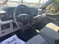 Interior of a 2023 Ford F-350 SD with a modern dashboard steering wheel and advanced infotainment system displaying navigation and controls for various features